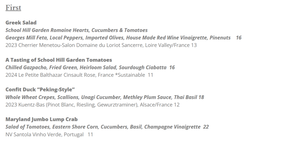 The Market Table Bistro’s First menu features Greek Salad, A Tasting of School Hill Garden Tomatoes, Confit Duck Peking-Style, and Maryland Jumbo Lump Crab—all with detailed descriptions, wine pairings, and prices from $11 to $22.