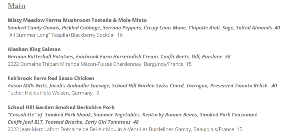 A restaurant menu section labeled Main at Market Table Bistro lists four entrees: Mushroom Tostada, Alaskan King Salmon, Red Sasso Chicken, and Berkshire Pork, each with detailed descriptions, prices, and suggested wine or beer pairings. Text is brown on a white background.