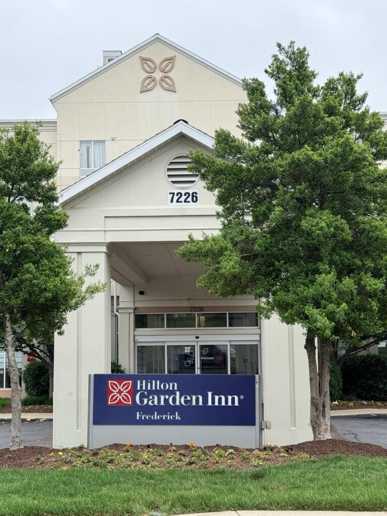 Hilton garden inn frederick md Hotel Entrance of Hilton Garden Inn with Address 7226 Surrounded by Green Trees