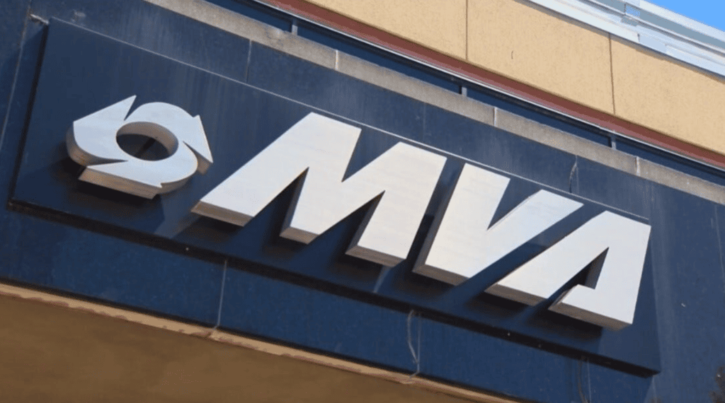 Exterior Storefront Sign with Large White Mma Letters and a Circular Logo on the Left Mounted on a Dark Blue Panel